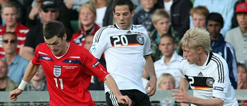 England's Adam Johnson receives the attention of Gonzalo Castro and Andreas Beck in Halmstad.